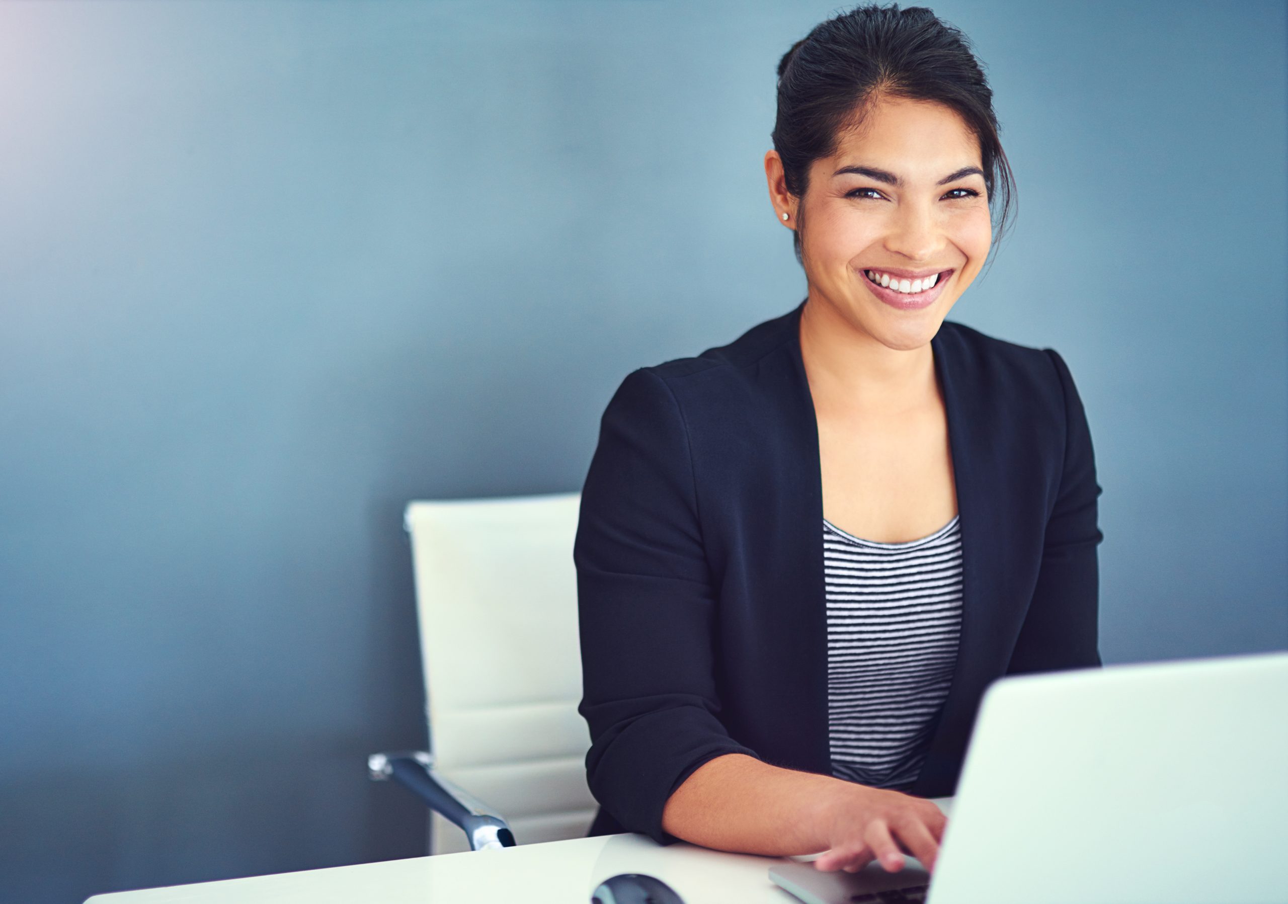 women at a desk working on a computer